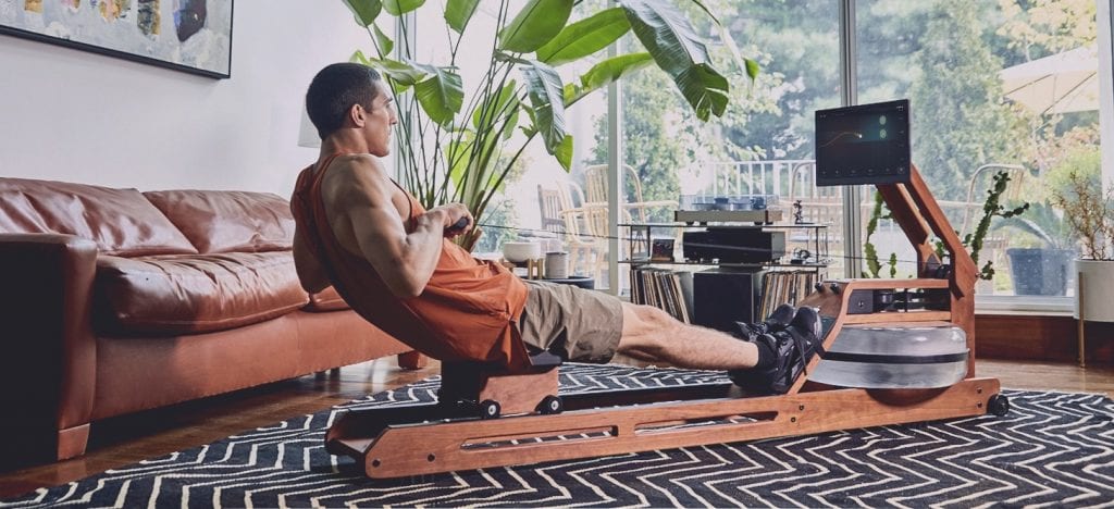 Man on rowing machine in his living room.